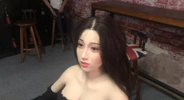 The head of the doll is made of silicone, and the hair is implanted with real human hair