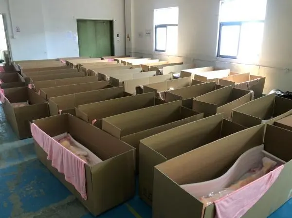 Adult dolls being packed in the factory